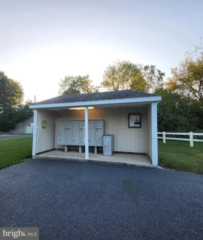 a front view of house with yard and mountain view in back
