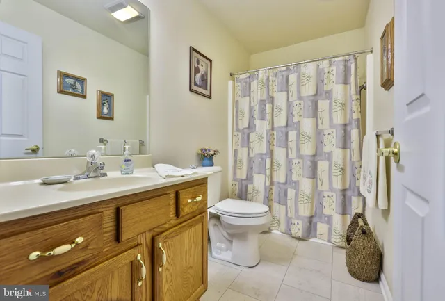 a bathroom with a double vanity sink toilet and shower