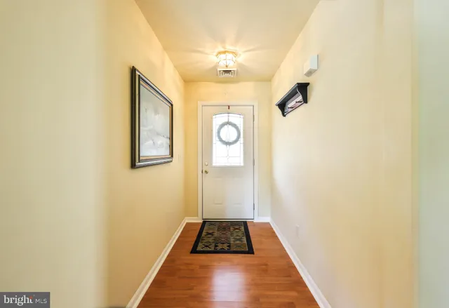 a view of a hallway view with wooden floor and staircase