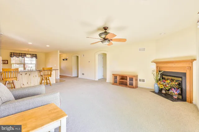 a view of a livingroom with furniture and a ceiling fan