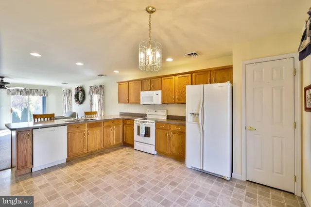 a kitchen with stainless steel appliances granite countertop a refrigerator and stove top oven