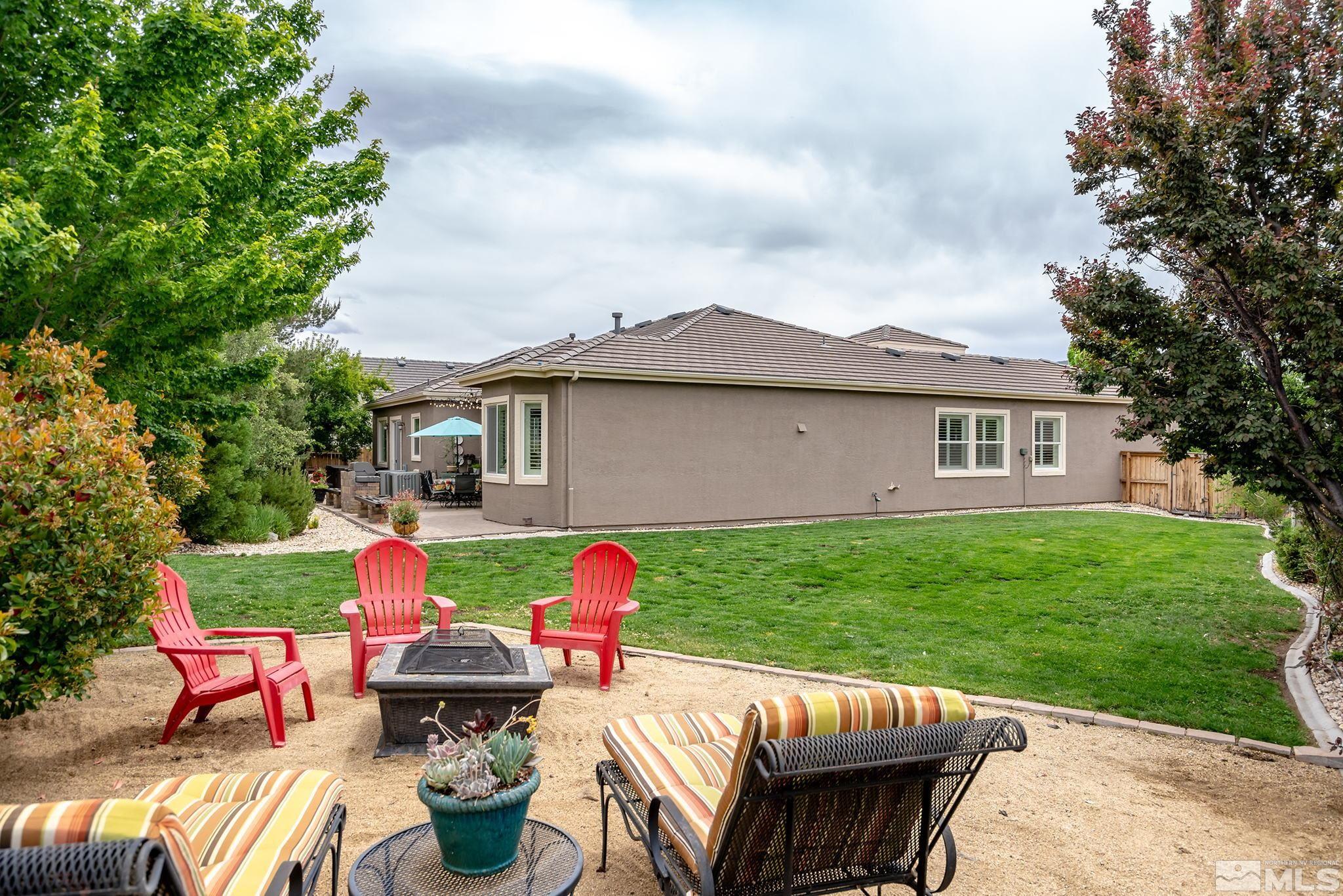 1585 Bethal Court Reno, NV 89521 - Photo 28 of 29 a view of a patio with table and chairs potted plants and a large tree
