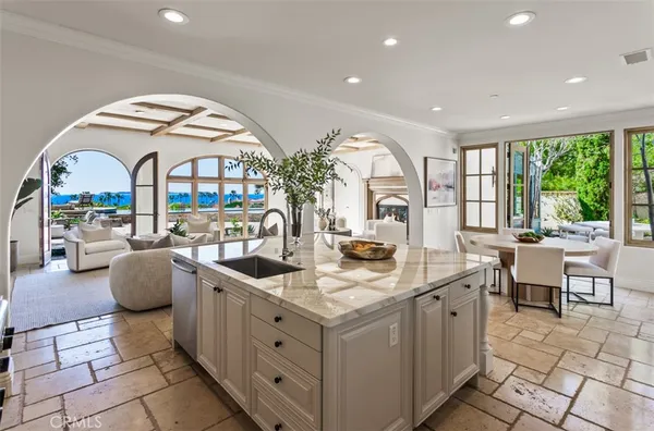 a kitchen with granite countertop a sink a stove and cabinets