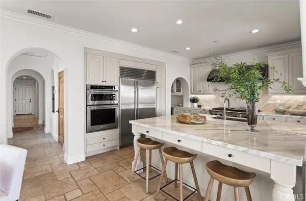 a kitchen with granite countertop a stove a sink and a microwave