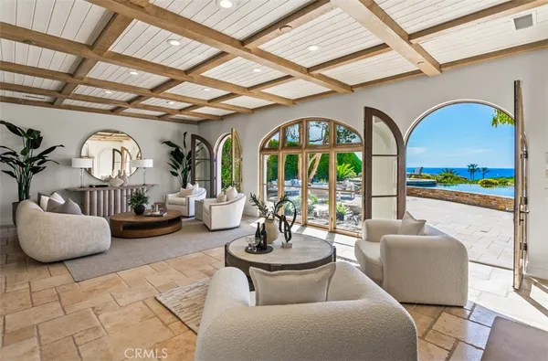 a living room with furniture fireplace and a large window