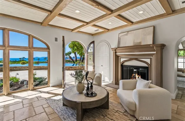 a dining room with furniture a chandelier and wooden floor