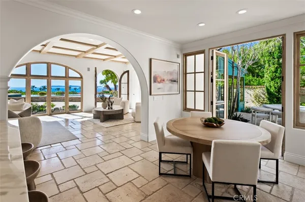 a view of a dining room with furniture large windows and wooden floor