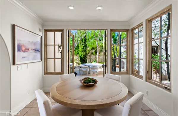 a kitchen with stainless steel appliances kitchen island granite countertop a table and chairs in it