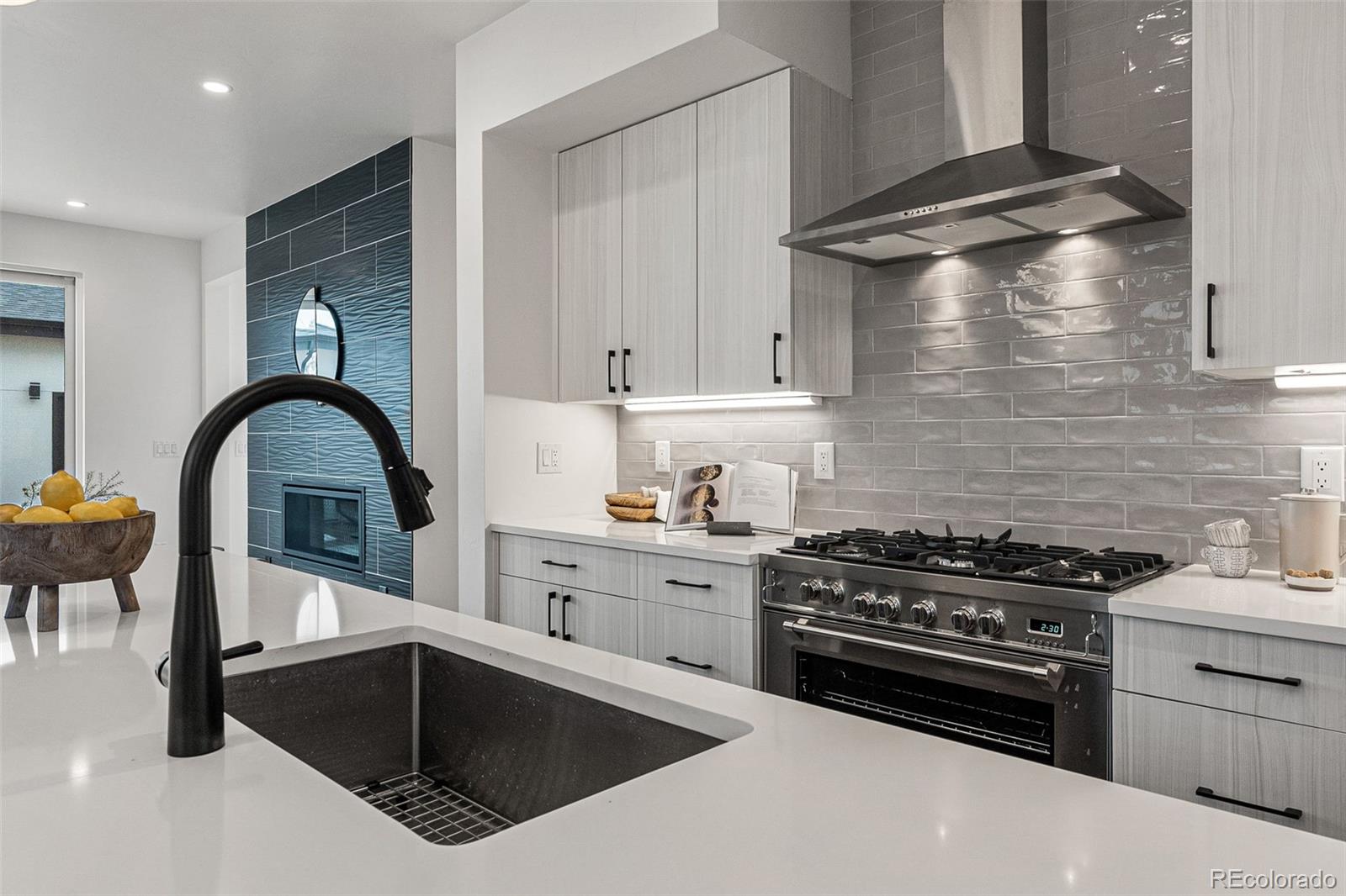 2410 South Bannock Street Denver, CO 80223 - Photo 13 of 40 a kitchen with granite countertop a stove and a sink
