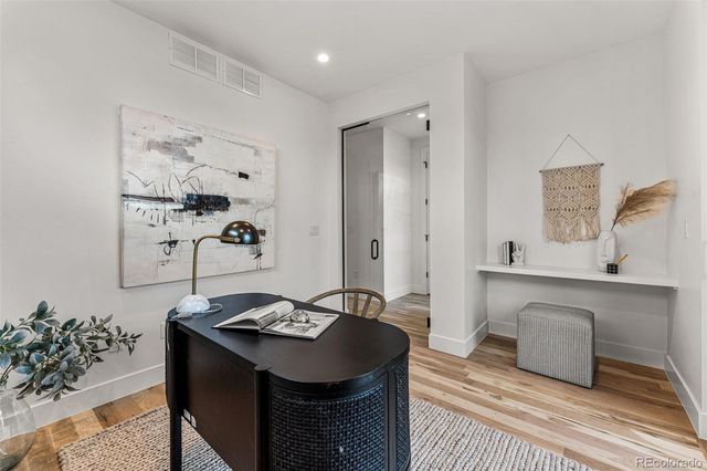 a living room with a sink and a table with chairs