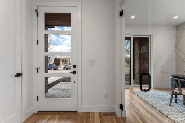 a view of a hallway and a livingroom with wooden floor