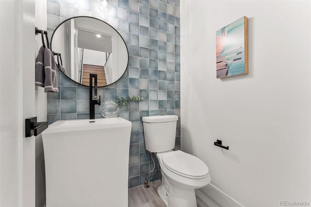 a bathroom with a toilet and a mirror