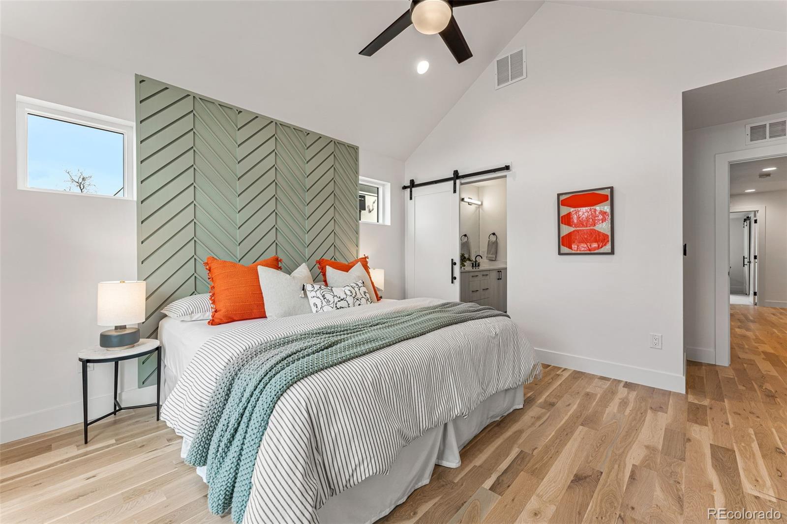 2410 South Bannock Street Denver, CO 80223 - Photo 21 of 40 a bedroom with a bed and a chandelier