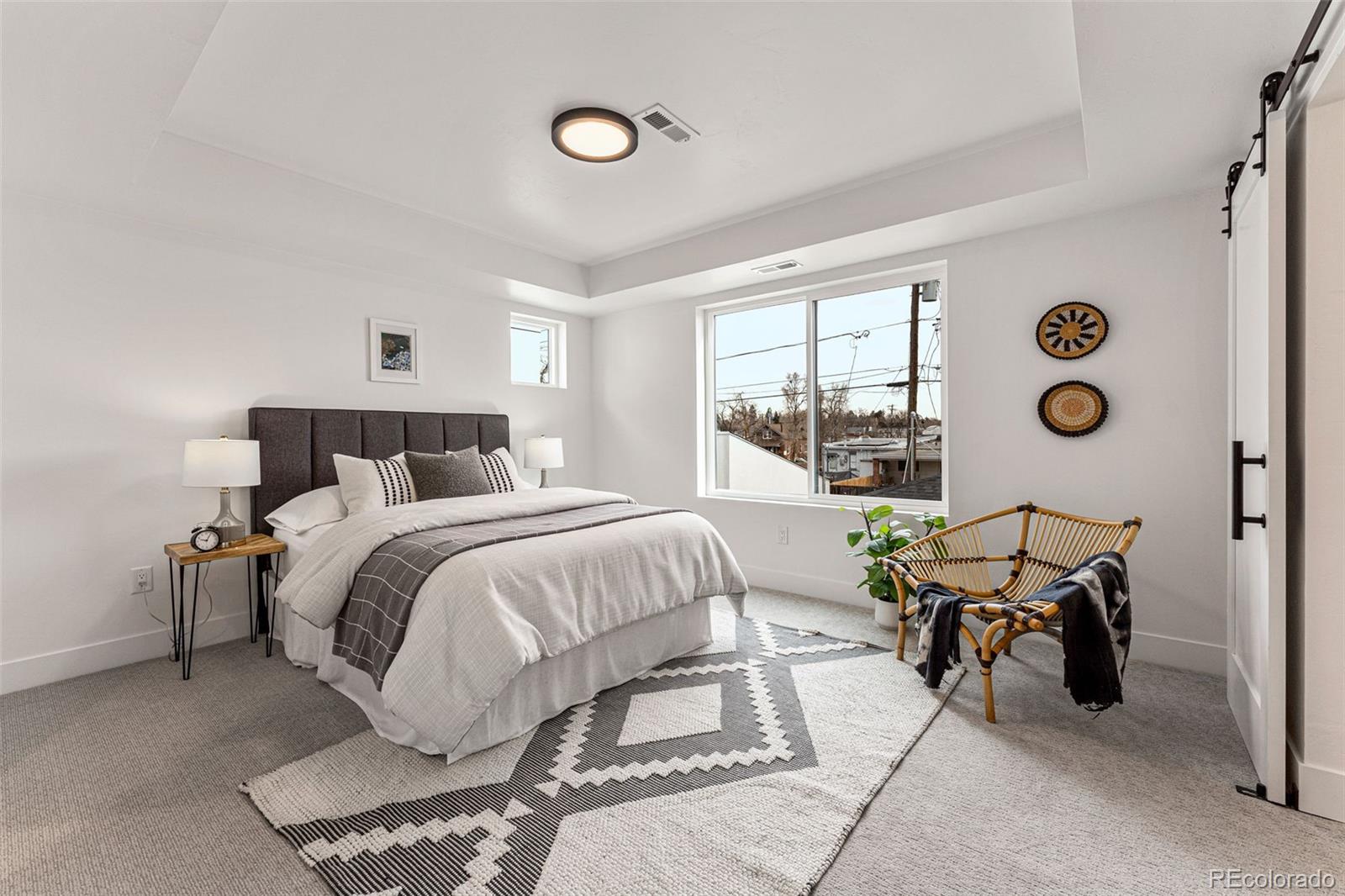2410 South Bannock Street Denver, CO 80223 - Photo 25 of 40 a bedroom with a bed and wooden floor