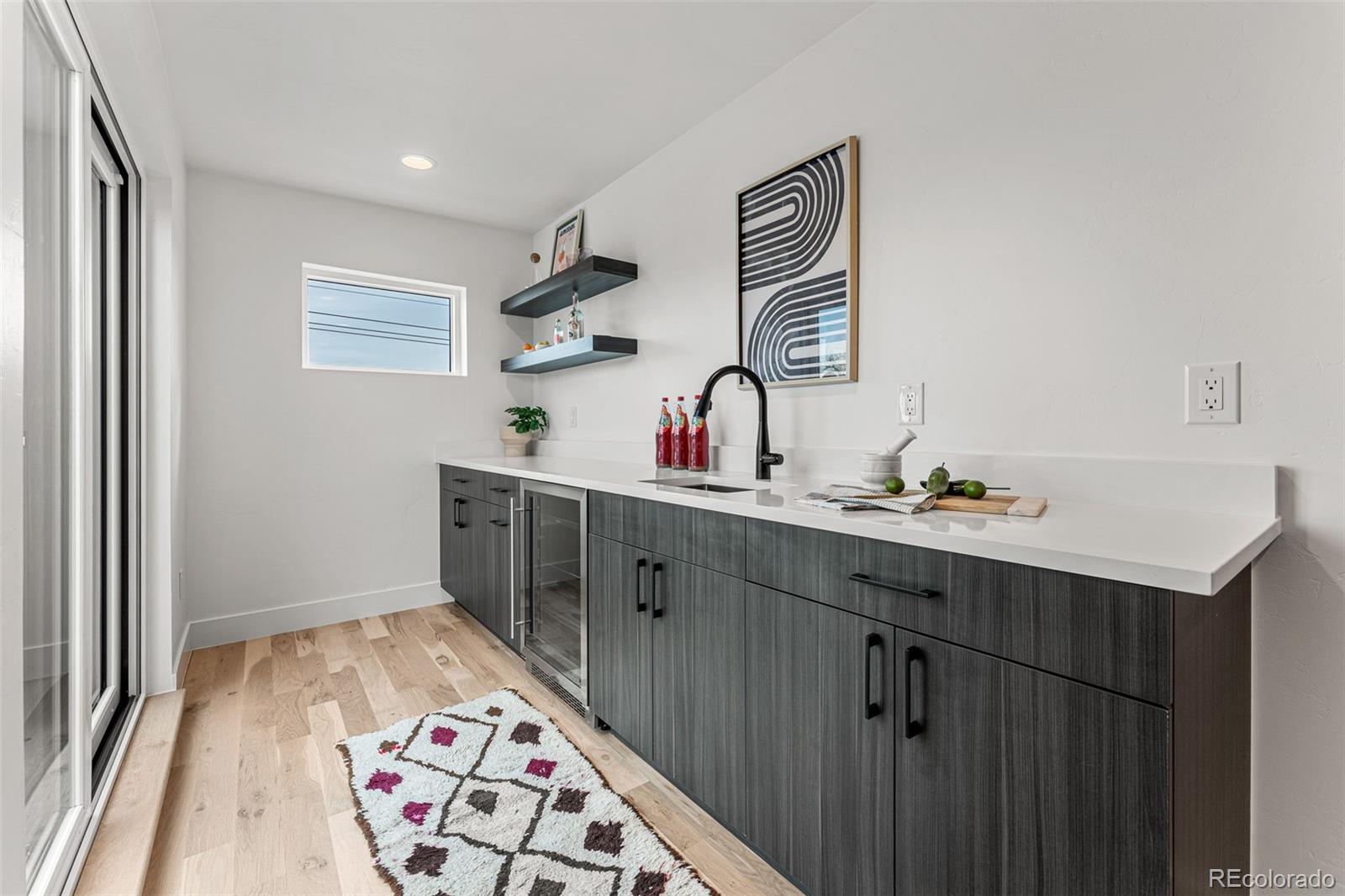 2410 South Bannock Street Denver, CO 80223 - Photo 29 of 40 a kitchen with a sink and a window