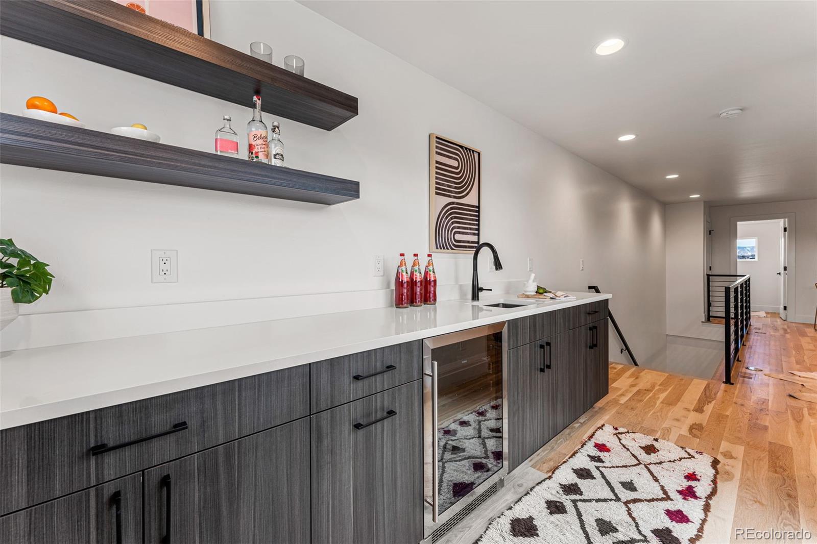 2410 South Bannock Street Denver, CO 80223 - Photo 30 of 40 a kitchen with stainless steel appliances a sink and cabinets