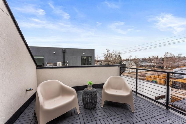 a balcony with table and chairs