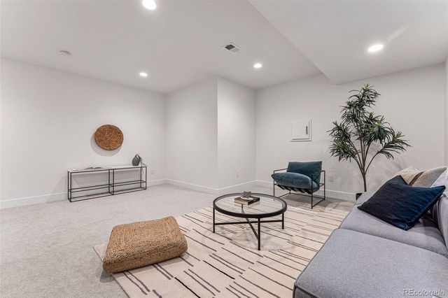 a living room with furniture and a potted plant