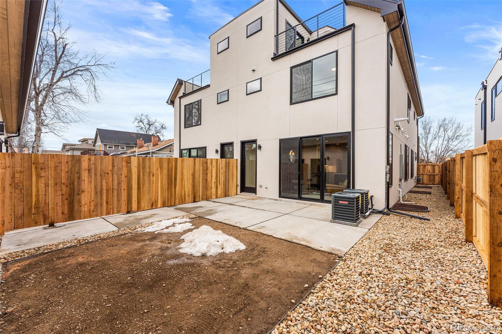 2410 South Bannock Street Denver, CO 80223 - Photo 37 of 40 a view of a house with a barbeque and wooden stairs