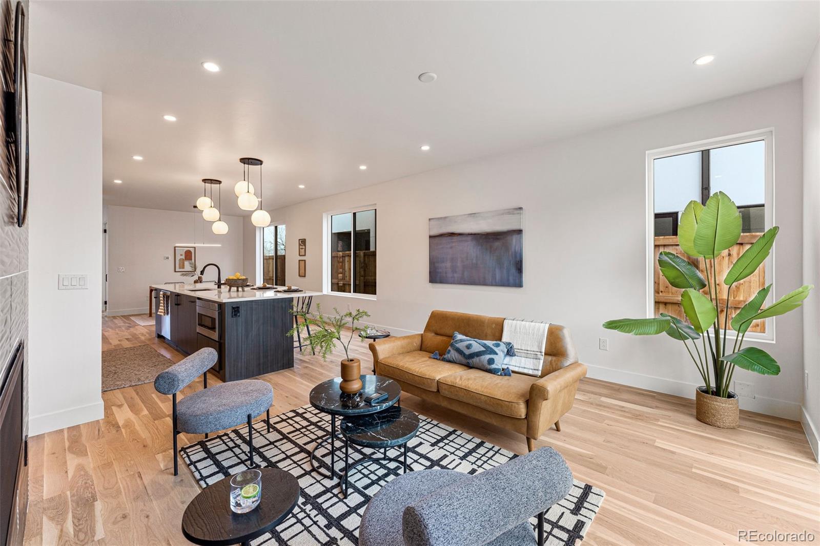 2410 South Bannock Street Denver, CO 80223 - Photo 5 of 40 a living room with furniture and a wooden floor