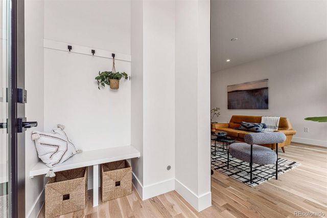 a view of a livingroom with furniture and hardwood floor