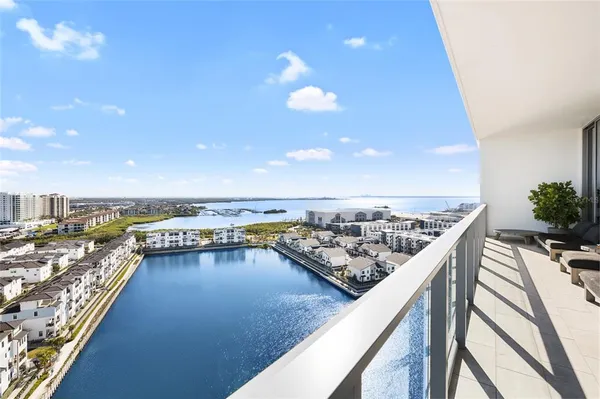 a bedroom with a large bed and a flat tv screen on dresser