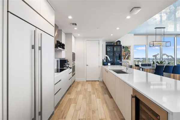 a hallway with wooden floor and windows