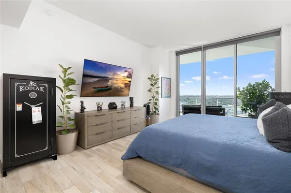 a view of a hallway with wooden floor and a living room