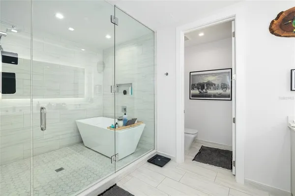 front view of house with a yard and potted plants