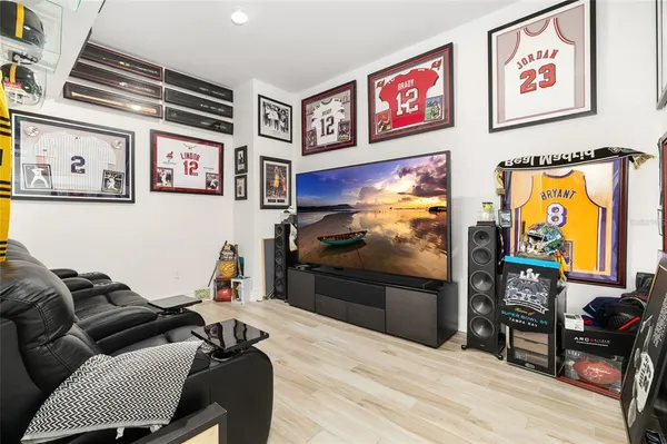 a living room with furniture a chandelier and a flat screen tv