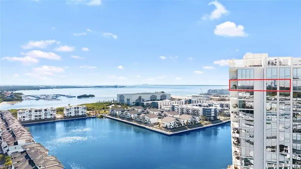 a view of a building with a swimming pool and sitting area