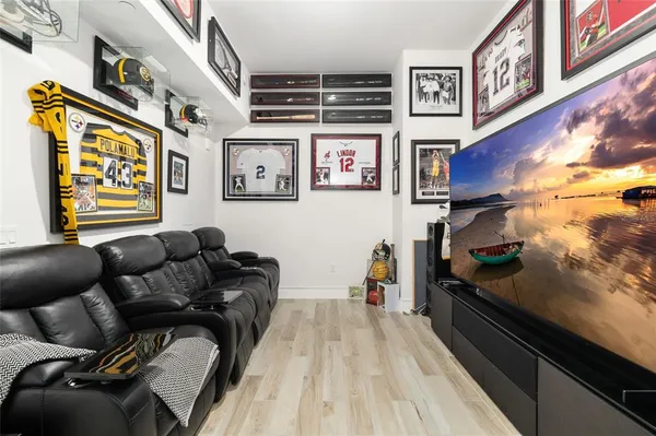 a room with furniture pool table and glass windows