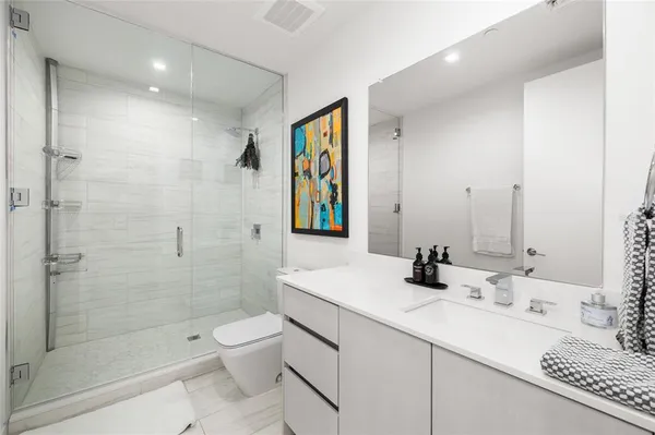 a kitchen with stainless steel appliances granite countertop a sink and a refrigerator