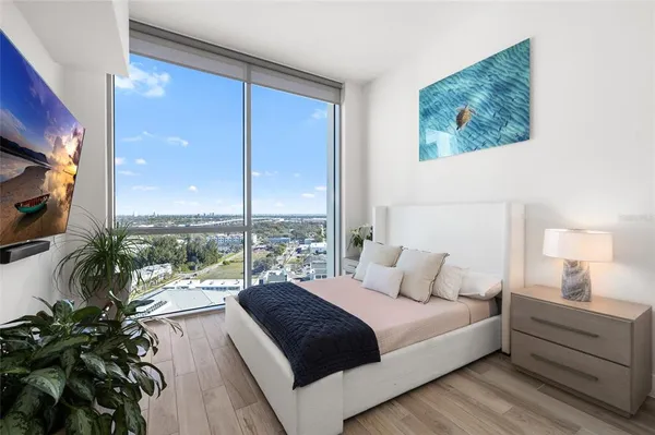 a living room with a fireplace and a ceiling fan