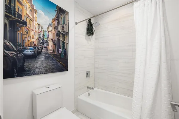 a bedroom with furniture and a large window