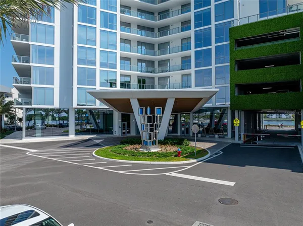 a living room with furniture kitchen view and a large window