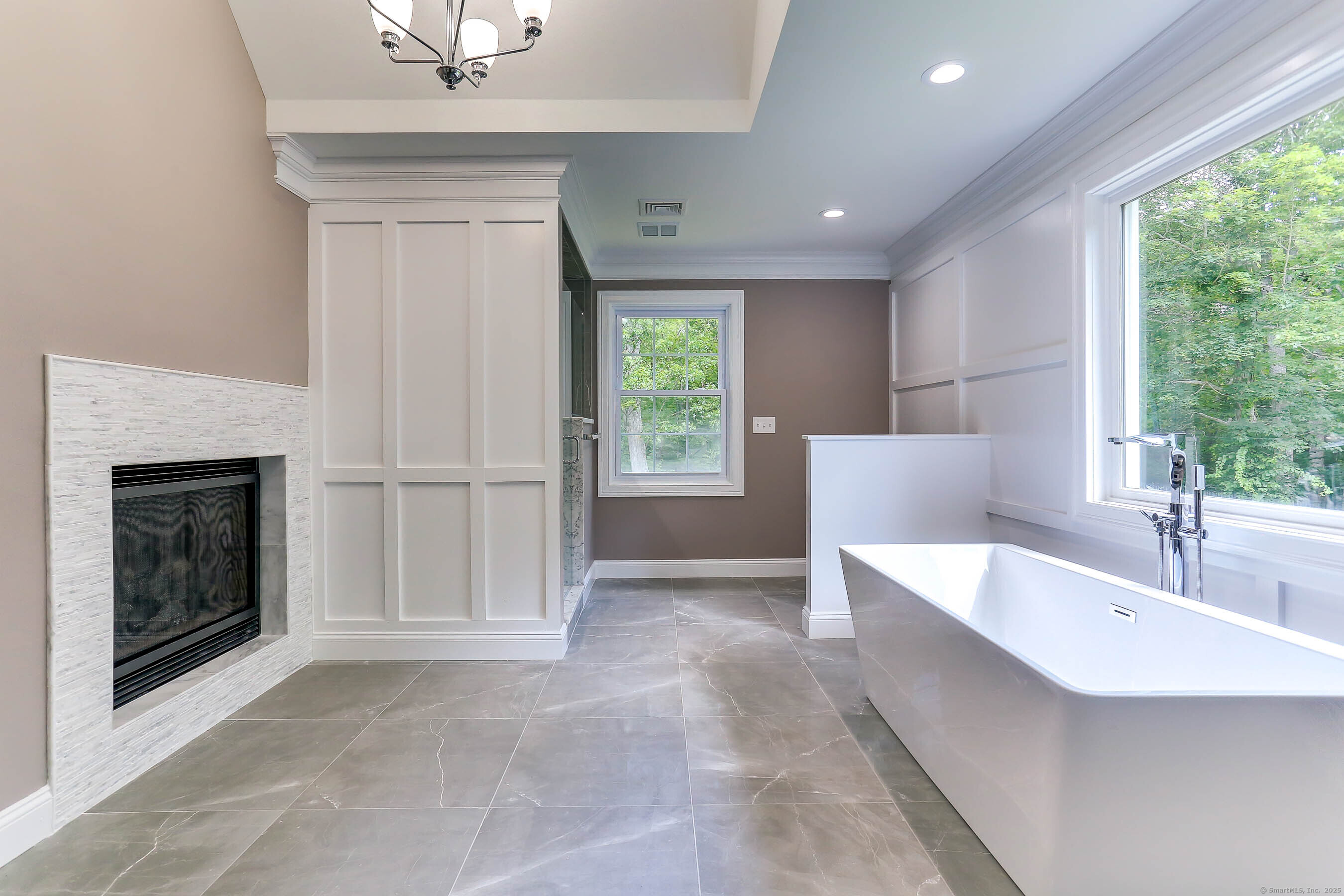 11 Buttonball Road Old Lyme, CT 06371 - Photo 16 of 37 Primary bath with walk-in shower, tub, dual vanities set in soothing color palette. This project included a double sided fireplace for the primary bedroom and bath!