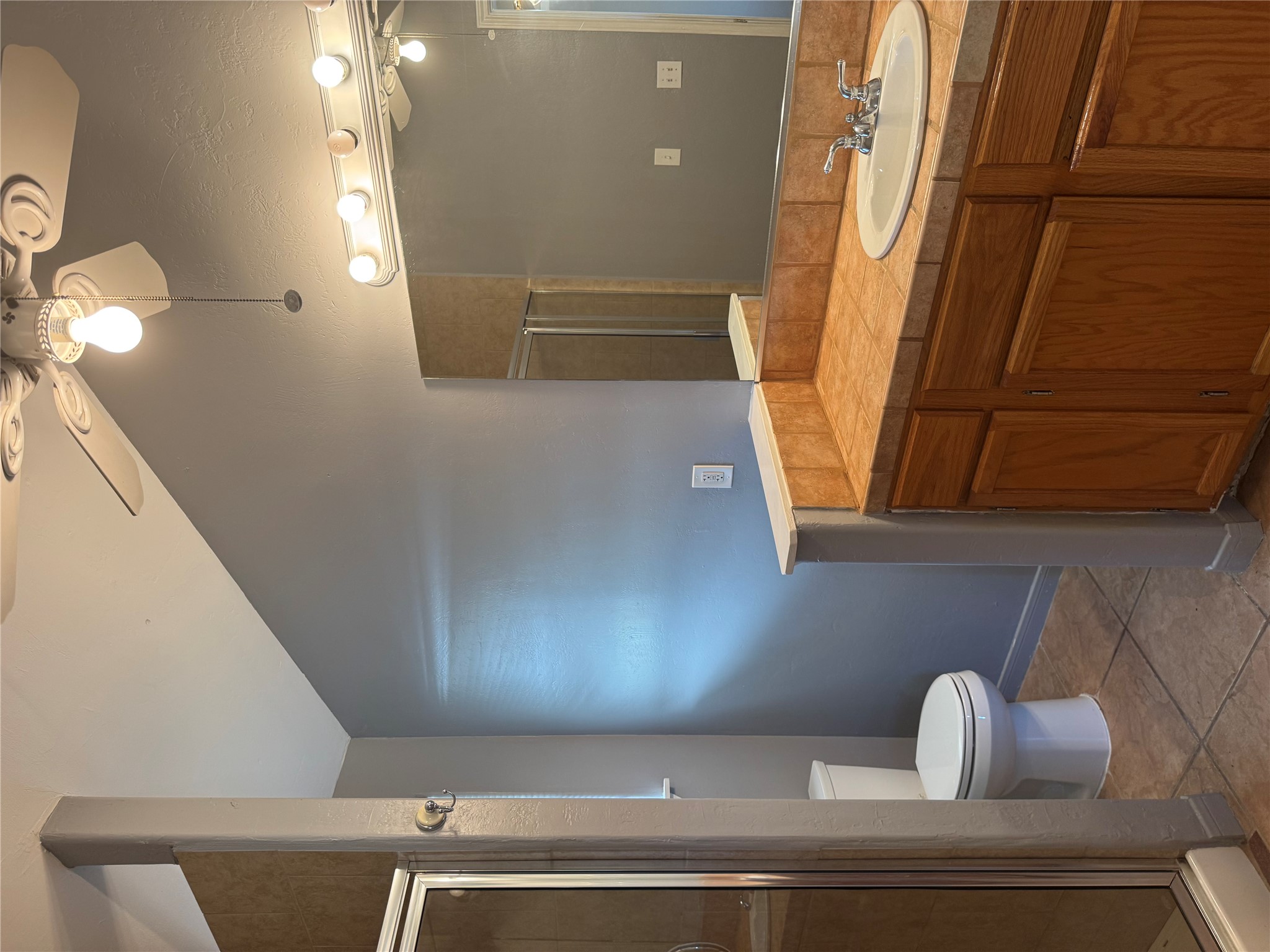 5300 Highway 290 Dripping Springs, TX 78620 - Photo 9 of 21 a bathroom with a sink a toilet and a mirror