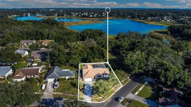 an aerial view of house with yard swimming pool and ocean view