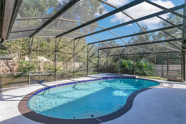 a view of a swimming pool with a yard