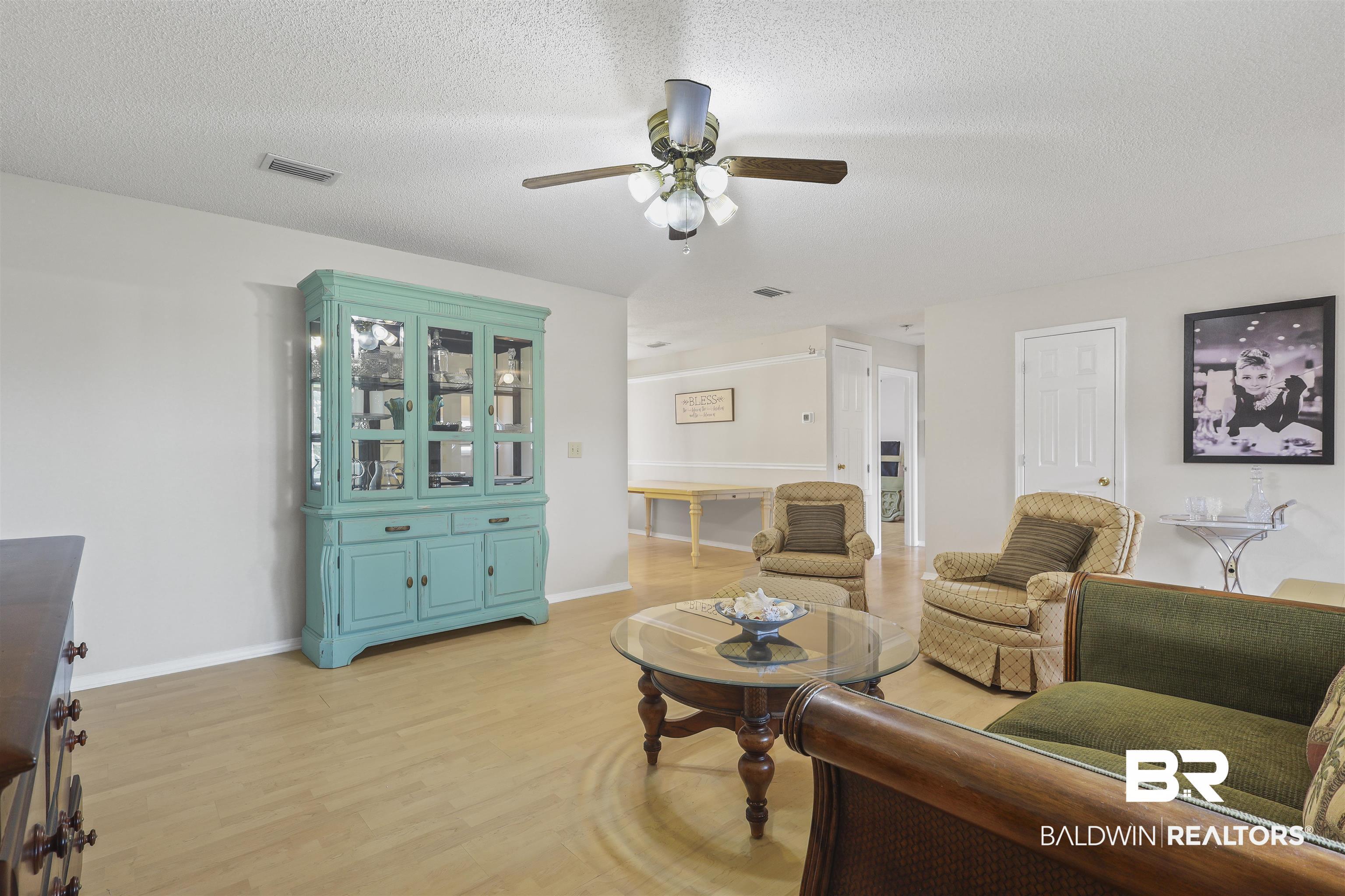 507 West Amanda Avenue Foley, AL 36535 - Photo 4 of 23 Living room with ceiling fan, a textured ceiling, and light wood-type flooring