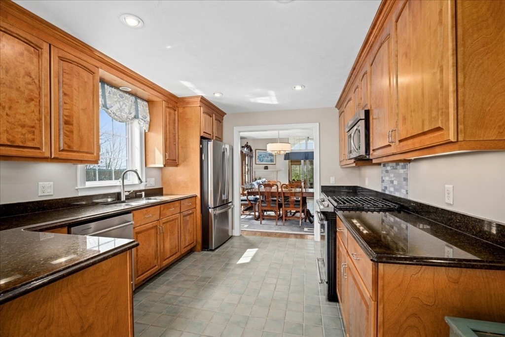 7 Primmett Lane, Unit 7 Worcester, MA 01609 - Photo 5 of 38 a kitchen with granite countertop a sink stainless steel appliances and cabinets