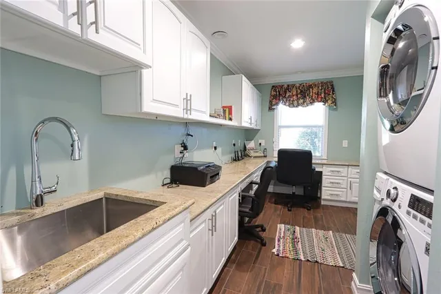a kitchen with a sink a stove and cabinets
