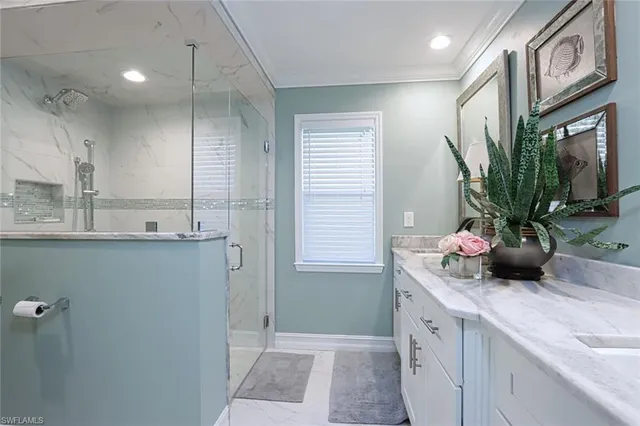 a bathroom with a double vanity sink a mirror and a shower