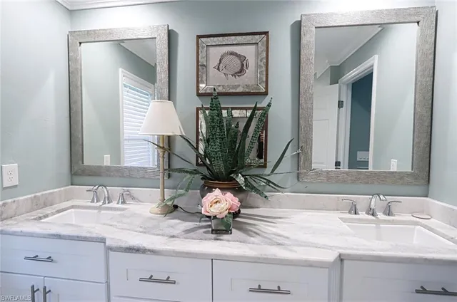 a bathroom with double vanity sinks a mirror and a shower