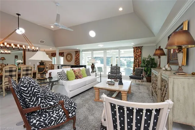 a living room with furniture a lamp and a large window