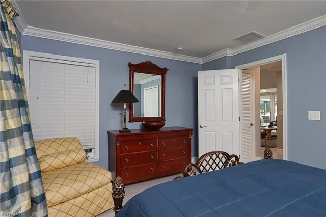 a bedroom with a bed and a dresser in it