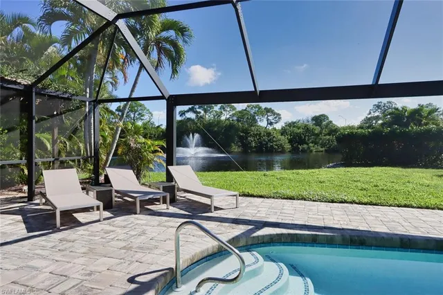 a view of a chairs and table in patio next to a yard
