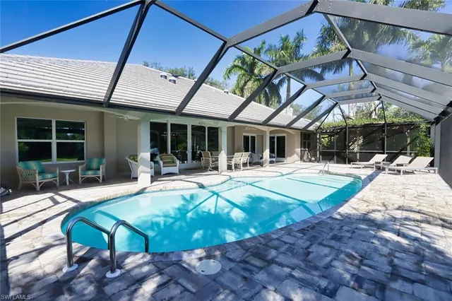 a view of a patio with swimming pool table and chairs