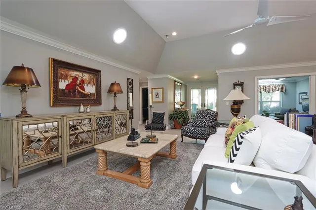 a living room with furniture a rug and white walls